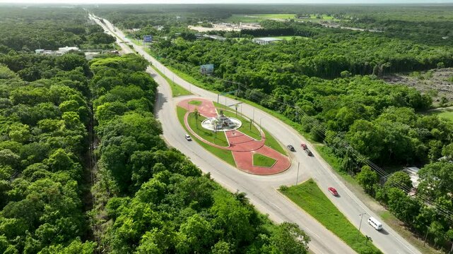 Villahermosa Chetumal Federal Highway 186 with Monument to the Mestizos surrounding vibrant green biosphere reserve, Quintana Roo, Panoramic drone view