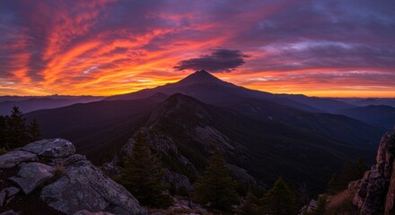 Obraz premium Fiery Sunset over Majestic Mountain Ranges