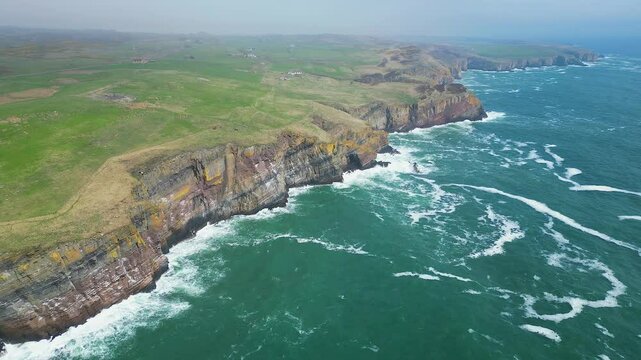 Aerial footage of the cliffs on the coast of Whaligoe town on a foggy day in Caithness, Scotland, UK