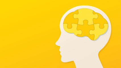 黄色いパズルのピースでできた脳と横顔のイラスト　黄色い背景
