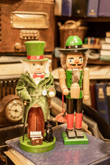 Unique nutcracker figurines, including one styled as Ebenezer Scrooge, displayed with vintage decor