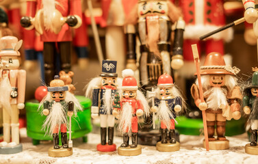 Close-up of small decorative nutcracker figurines in various styles and colors arranged on display
