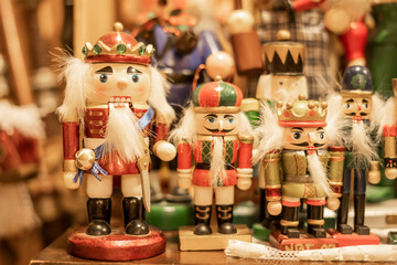 Wooden nutcracker figurines in vibrant holiday-themed uniforms