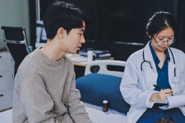 Female physician reads medical history while visiting her patient