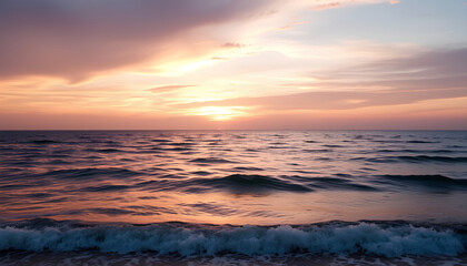 Obraz premium A breathtaking view of the ocean at sunset, with golden and pink hues reflecting on the calm waves