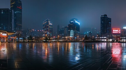 Fototapeta premium 62.Wide-angle view of a wet asphalt square under soft city lights, with Chongqing's modern skyscrapers glowing brightly against a deep blue night sky.