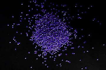 Purple pearl masterbatch granules, isolated on black background, color pigment carrier polymer in...