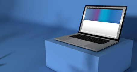 Open laptop with web page on screen on blue table against blue background