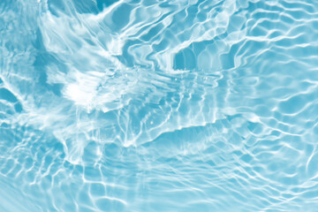 Blue water with ripples on the surface. Defocus blurred transparent blue colored clear calm water...