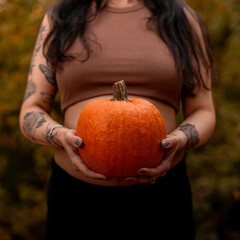 Pregnant woman with a pumpkin