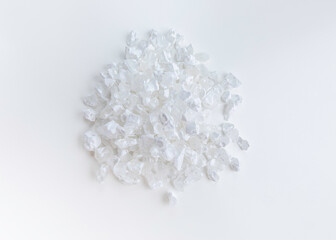 A pile of lemon salt crystals on a white background. Top view. Citric acid or Lemon salt on white background.