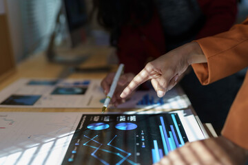 Professionals Analyzing Data on Digital Tablet