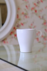 top view shot of a pink and green theme with pink flowers wallpaper,  and partially visible white cup set with text space for your message, love, soft, feminine and romantic valentines concept