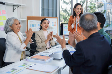 Business team clapping hands during a meeting in the office