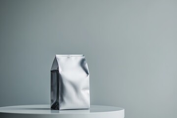 Sleek metallic packaging on minimalist table enhances modern aes