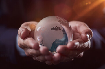 Fototapeta premium world, earth, planet, business concept glass earth globe in the hands