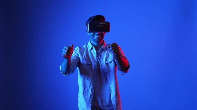 Professional gamer with casual cloth wearing VR goggle while driving car in virtual world. Male model using accessing metaworld by using virtual reality headset while playing racing game. Apparatus.