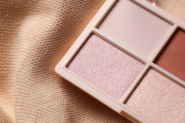 Fototapeta premium Makeup eyeshadow palette on beige velour background