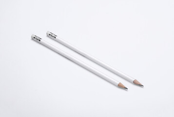 White wooden pencils with erasers on white background. Mockup for design