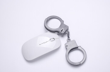 Pc mouse with handcuffs on white background. Cyber ​​police, online crimes