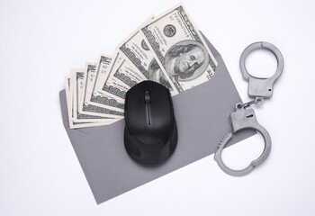 Envelope with money and handcuffs, pc mouse on a white background. Corruption, crime, Cyber...
