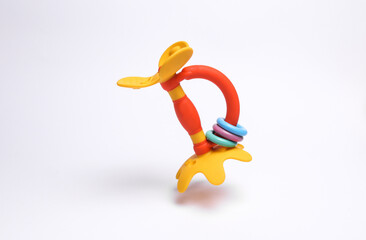 Rattle toy for newborn floating on white background