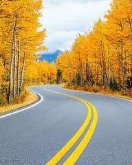 Fototapeta premium Winding road through vibrant autumn trees with golden leaves