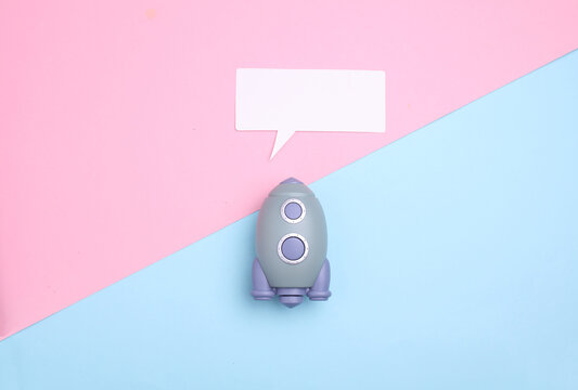 Pear-shaped space shuttle and speech bubble on blue pink background. Startup idea