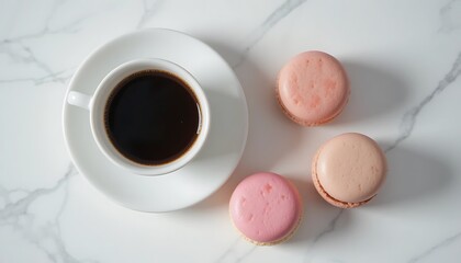A cup of black coffee with three pink macarons on a marble table