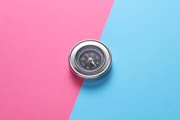 Metal tourist compass on pink blue background © splitov27