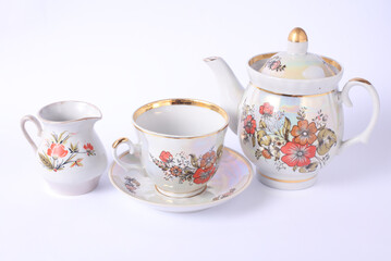 Set of vintage ceramic tea set on white background