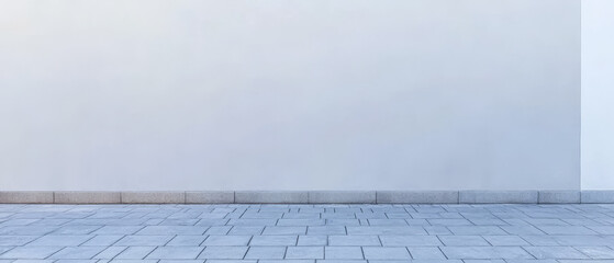 Obraz premium Clean white wall with stone floor in an open area during daylight
