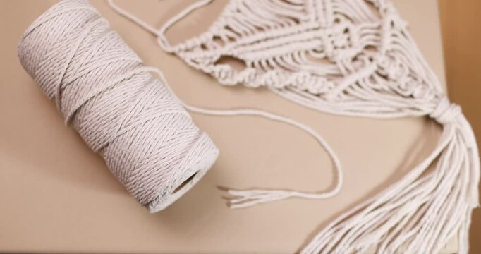 macrame and cotton threads on light background, suitable for banners and advertising of macrame and boho crafts
