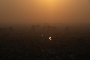 Fototapeta premium PM 2.5 dust in the atmosphere in the city,blurred sky dark with air pollution smoke cloud dust mist for background, problem in atmosphere sky environment, toxic pollution in atmosphere smog mist for