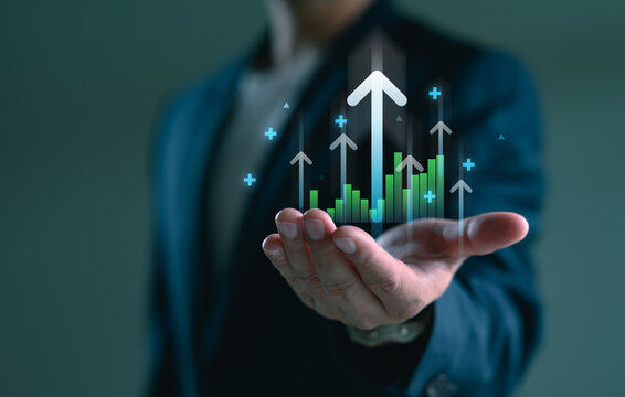 Hand holding growth business strategy arrow concept on success target improvement with increase development graph profit or economy investment income target and goal increase achievement.