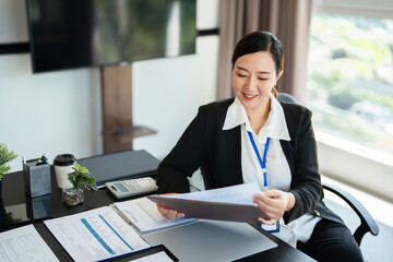 Mid age businesswoman working with document in office.