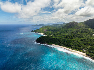 Tropical beach and rocks in turquoise water. Seychelles, Mahe. Anse Bazarca Beach.