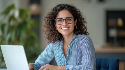 Smiling woman working laptop office background