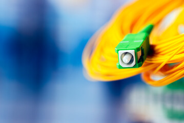 Fiber Optic Connector Close-up and Optical Distribution Frame with Soft-focus Blurred Background