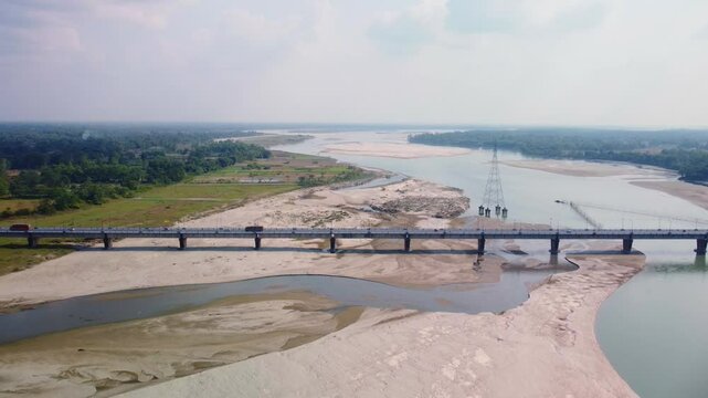 Highway road bridge over dry Torsa River near Cooch Behar in winter flows through China, Bhutan, India, and Bangladesh, West Bengal, Aerial revealing shot