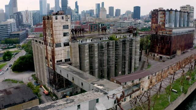Aerial shot of an old shipping yard in Montreal, featuring rows of weathered containers and industrial cranes. Captures the raw, historical charm of the port's past operations.