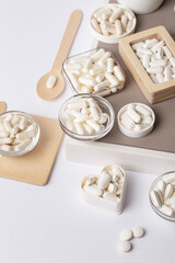 Organic dietary supplements, minerals and vitamins such as such as vitamin d3, a, e, b, c, fish oil, magnesium, zinc and calcium in beautiful composition from above on white background. Many pills