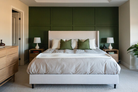 Large mid-century modern bedroom with green accent wall.