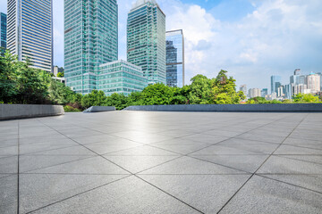 Fototapeta premium Empty square floor and modern city buildings on a sunny day