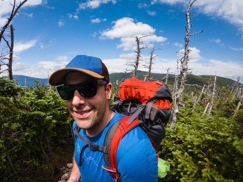 Male backpacker hiking through New Hampshire's Pemigewasset Wilderness