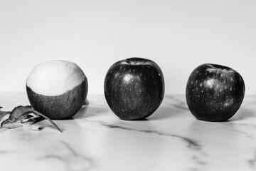 Three apples on marble countertop