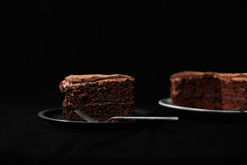 Slice of rich chocolate cake with buttercream