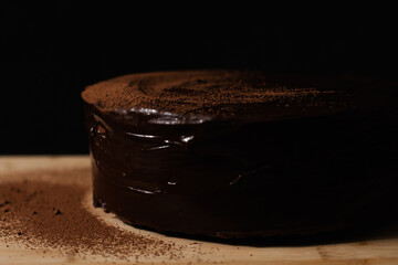 Rich chocolate ganache cake with cocoa powder