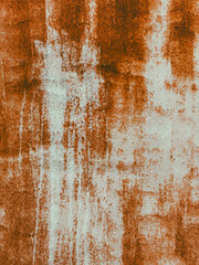The wall is covered in rust and has a rough texture