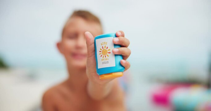 Hand, sunscreen and youth with boy child outdoor at swimming pool in garden of home for product marketing. Advertising, bottle and uv protection with kid in backyard to promote spf cream for summer